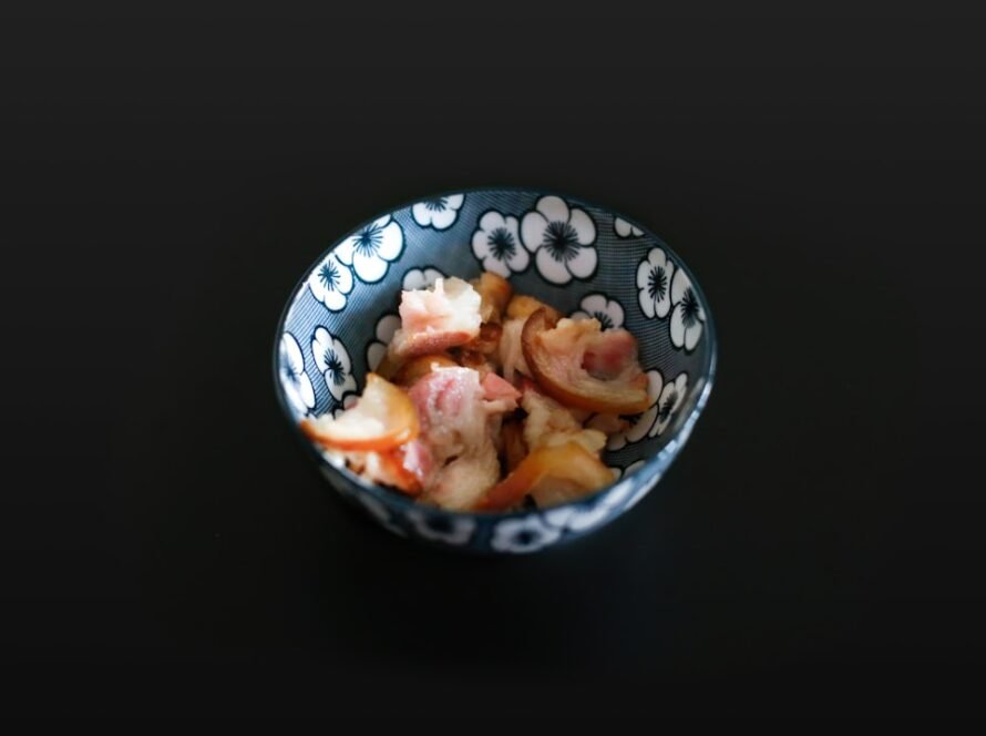 a bowl of food on a black surface