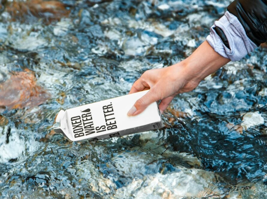 Hand holding carton in stream