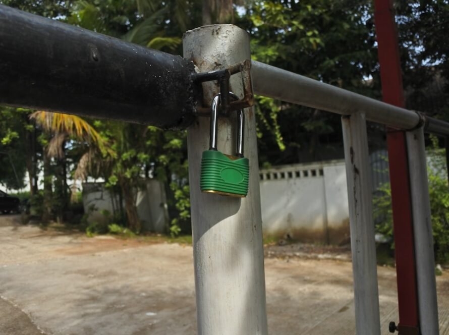 Green padlock on metal gate